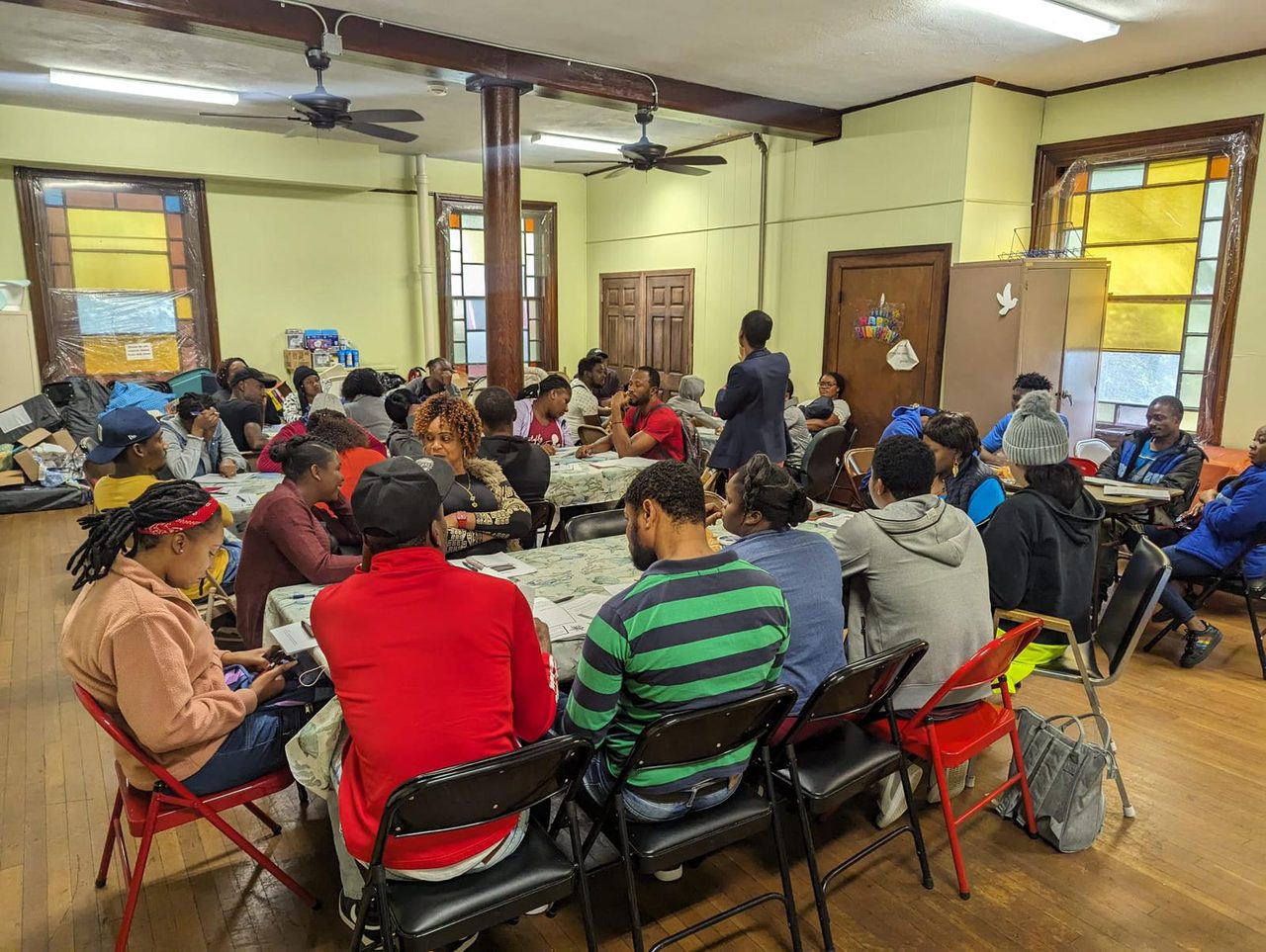 Participants seated at tables during a SaveSouls workshop.